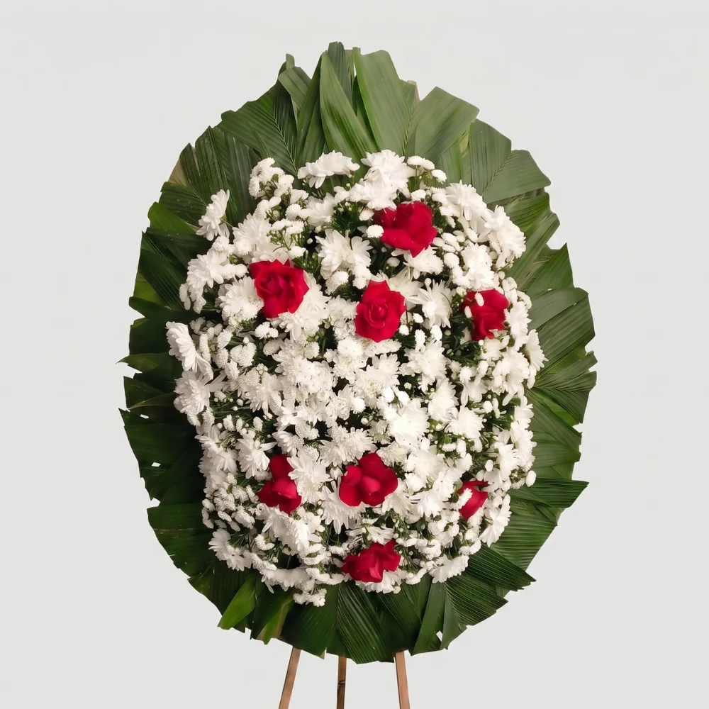 Coroa de flores essencial para velório com rosas amarelas e folhagem delicada — modelo Essencial Afeto